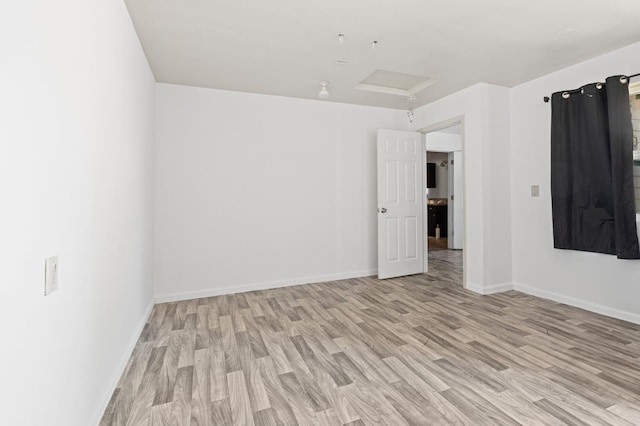 3334 E Montecito Ave, Fresno, CA 93702 - empty room with light wood-style floors and attic access