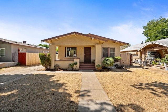 3334 E Montecito Ave, Fresno, CA 93702 - bungalow-style house with stucco siding, covered porch, and a gate