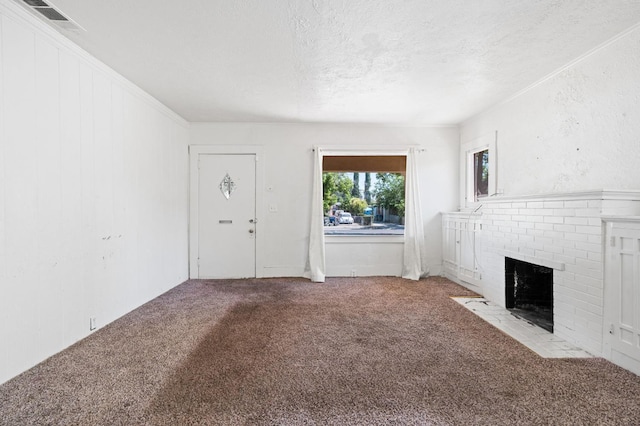 3334 E Montecito Ave, Fresno, CA 93702 - unfurnished living room featuring carpet flooring, a textured ceiling, and a brick fireplace
