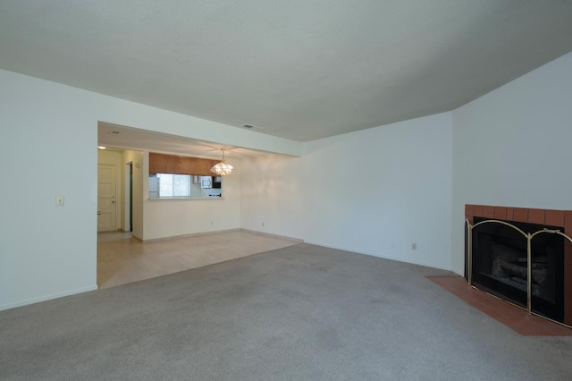 4875 N Backer Ave Unit 160, Fresno, CA 93726 - unfurnished living room featuring a fireplace, a chandelier, and carpet