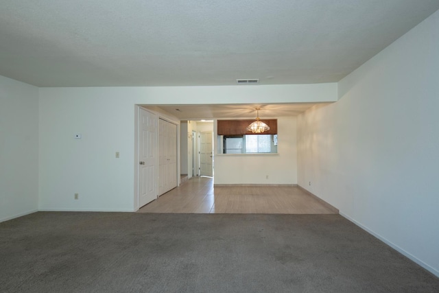 4875 N Backer Ave Unit 160, Fresno, CA 93726 - unfurnished living room featuring carpet and a chandelier
