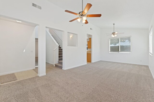 4220 Spruce St, Firebaugh, CA 93622 - unfurnished living room with a ceiling fan, vaulted ceiling, light colored carpet, and stairs