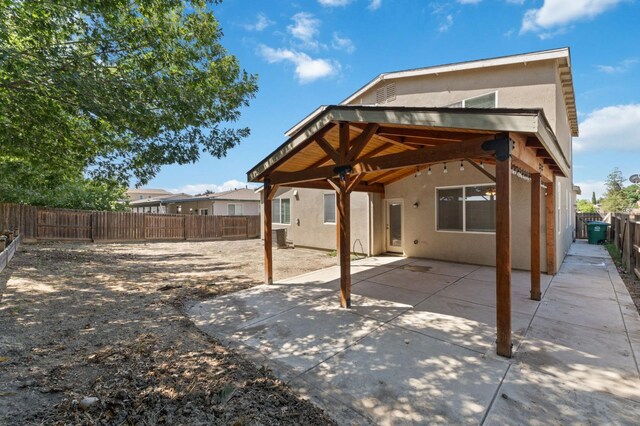 4220 Spruce St, Firebaugh, CA 93622 - rear view of property with stucco siding, a patio, and a fenced backyard