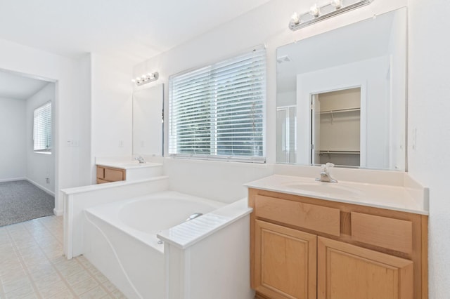 4220 Spruce St, Firebaugh, CA 93622 - full bath with vanity, a bath, a walk in closet, and tile patterned floors