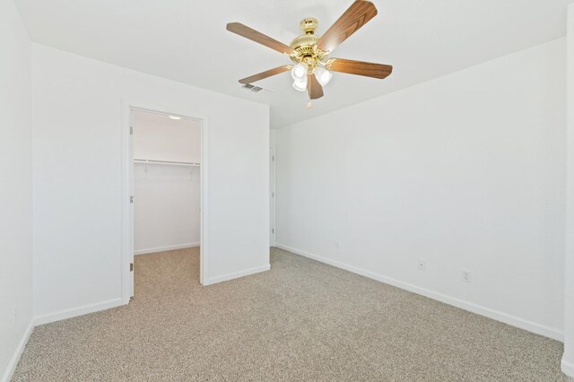 4220 Spruce St, Firebaugh, CA 93622 - unfurnished bedroom featuring light carpet, a walk in closet, and ceiling fan