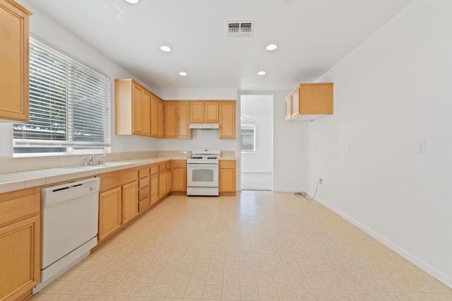 4220 Spruce St, Firebaugh, CA 93622 - kitchen with white appliances, under cabinet range hood, recessed lighting, tile countertops, and light brown cabinets