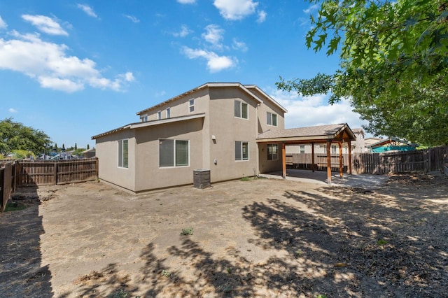 4220 Spruce St, Firebaugh, CA 93622 - rear view of house with stucco siding, a fenced backyard, and a patio area