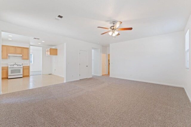4220 Spruce St, Firebaugh, CA 93622 - unfurnished living room featuring a ceiling fan, light colored carpet, and recessed lighting