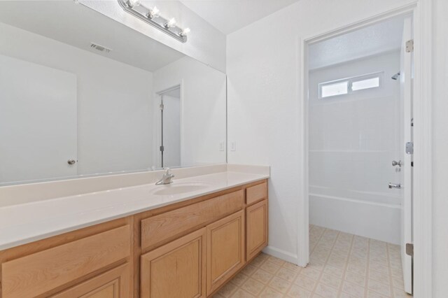4220 Spruce St, Firebaugh, CA 93622 - bathroom featuring vanity, tile patterned floors, and washtub / shower combination