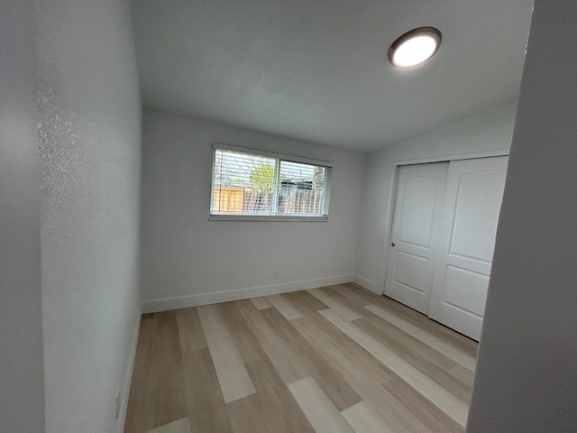 1223 E Drummond Ave, Fresno, CA 93706 - unfurnished bedroom featuring light wood finished floors, a closet, and vaulted ceiling