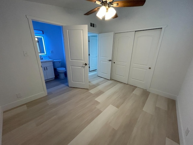 1223 E Drummond Ave, Fresno, CA 93706 - unfurnished bedroom with light wood-style flooring, a closet, connected bathroom, and ceiling fan