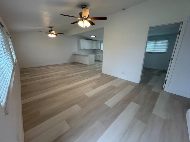 1223 E Drummond Ave, Fresno, CA 93706 - unfurnished living room featuring ceiling fan, vaulted ceiling, and light wood-type flooring