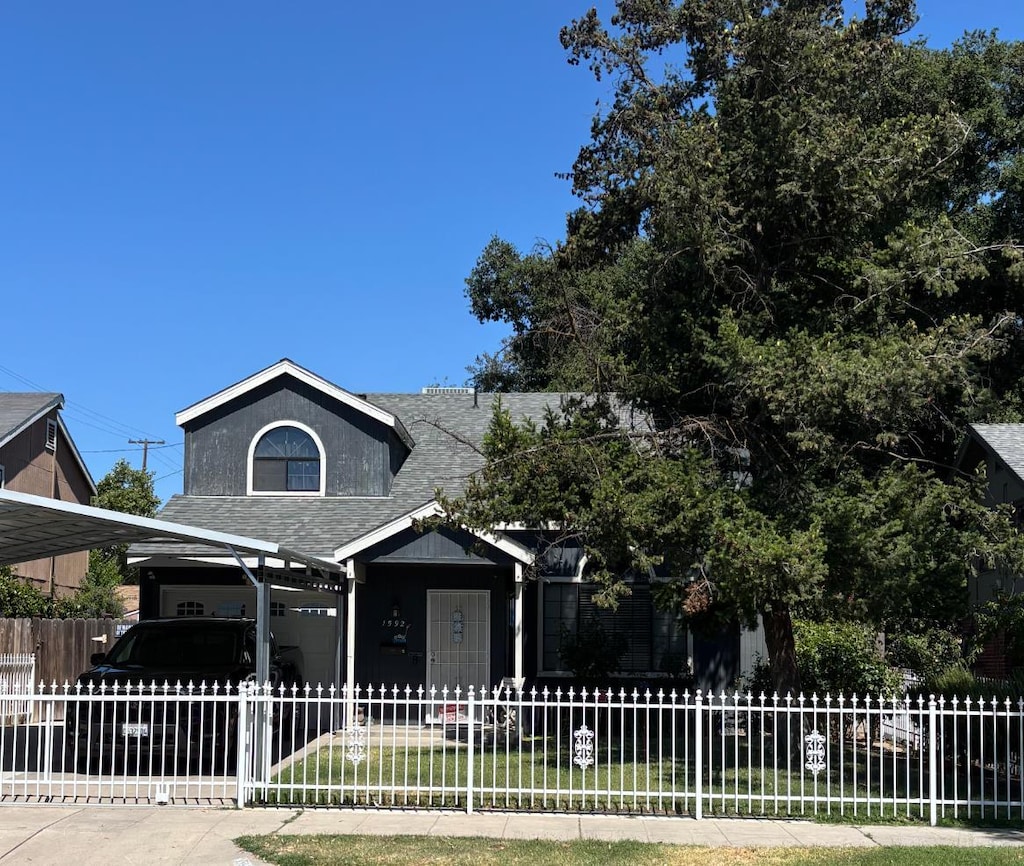 1592 N Ferger Ave, Fresno, CA 93728 - view of front of house featuring a shingled roof, a fenced front yard, and a carport