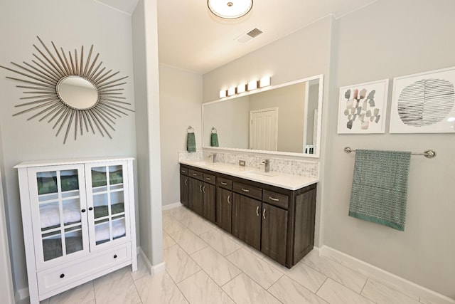 1082 E Oakmont, Fresno, CA 93730 - full bath with marble finish flooring, double vanity, and backsplash