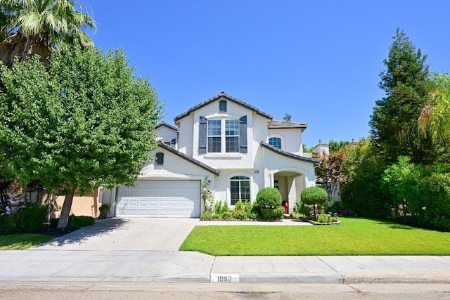 1082 E Oakmont, Fresno, CA 93730 - view of front of property with an attached garage, a front yard, driveway, and stucco siding