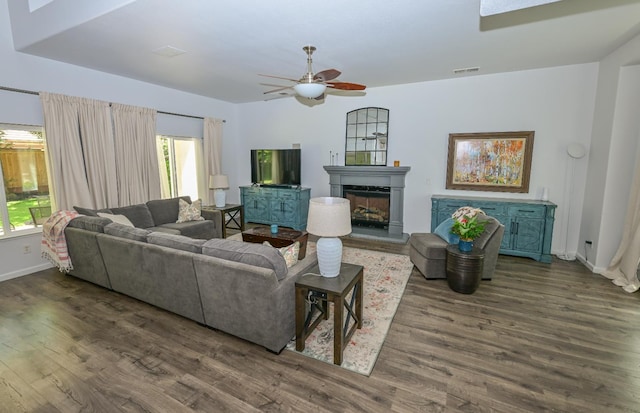 1082 E Oakmont, Fresno, CA 93730 - living area featuring dark wood finished floors, a ceiling fan, and a fireplace with raised hearth