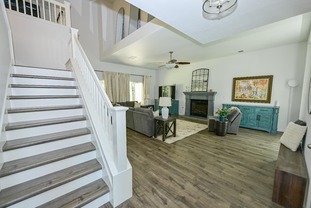 1082 E Oakmont, Fresno, CA 93730 - living room with stairs, wood finished floors, ceiling fan, and a fireplace with raised hearth