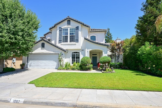 1082 E Oakmont, Fresno, CA 93730 - mediterranean / spanish house featuring a front yard, concrete driveway, stucco siding, and a tile roof