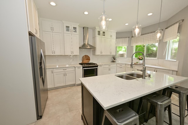 1082 E Oakmont, Fresno, CA 93730 - kitchen with wall chimney exhaust hood, stainless steel appliances, decorative backsplash, recessed lighting, and white cabinets