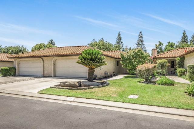 115 Prince Ln, Madera, CA 93637 - mediterranean / spanish-style home featuring concrete driveway, a tile roof, stucco siding, and a front yard