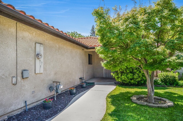 115 Prince Ln, Madera, CA 93637 - entrance to property featuring a yard, stucco siding, and a tile roof