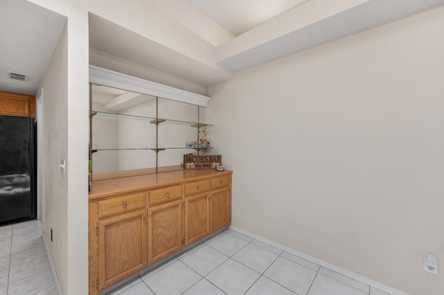 115 Prince Ln, Madera, CA 93637 - bar area featuring black refrigerator and light tile patterned floors