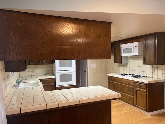 6924 N Winery, Fresno, CA 93710 - kitchen with white appliances, decorative backsplash, and tile counters