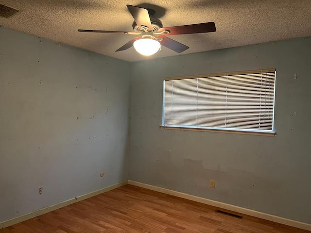 6924 N Winery, Fresno, CA 93710 - spare room with wood finished floors, a ceiling fan, and a textured ceiling