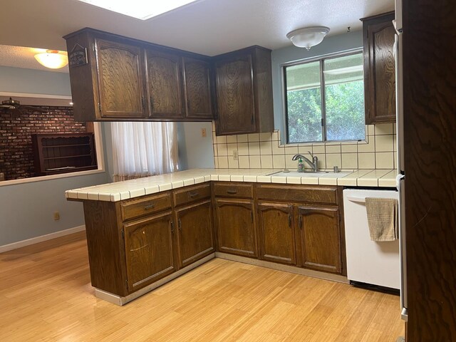 6924 N Winery, Fresno, CA 93710 - kitchen featuring dishwasher, light wood-style flooring, freestanding refrigerator, and tile counters