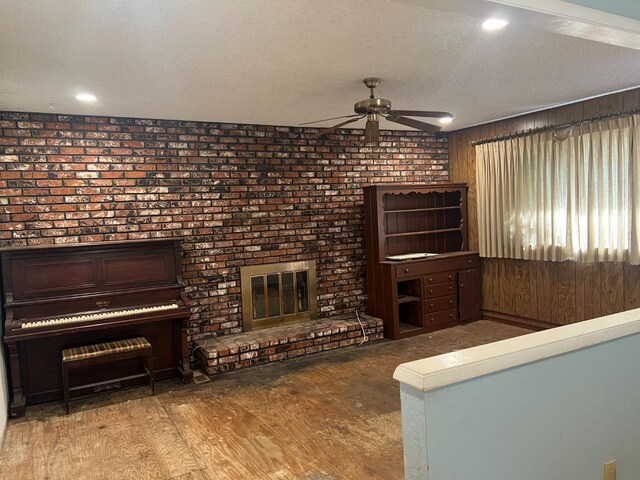 6924 N Winery, Fresno, CA 93710 - living area with ceiling fan, a fireplace, wood finished floors, a textured ceiling, and recessed lighting