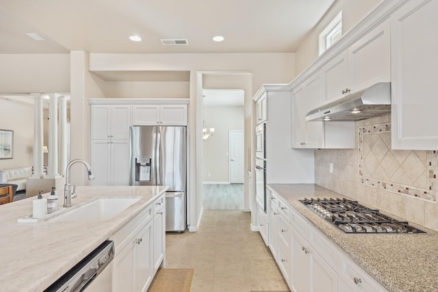 10911 E Swift Ave, Clovis, CA 93619 - kitchen featuring appliances with stainless steel finishes, under cabinet range hood, white cabinetry, backsplash, and recessed lighting