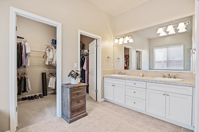 10911 E Swift Ave, Clovis, CA 93619 - full bath with double vanity, a spacious closet, and tile patterned flooring