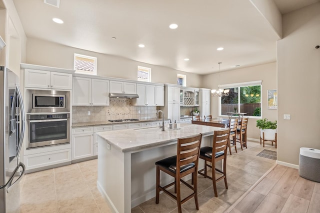 10911 E Swift Ave, Clovis, CA 93619 - kitchen featuring stainless steel appliances, tasteful backsplash, a chandelier, white cabinets, and recessed lighting
