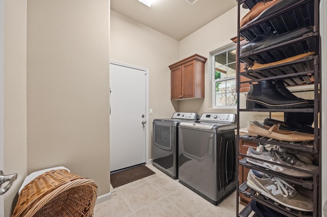 10911 E Swift Ave, Clovis, CA 93619 - laundry room with cabinet space, washer and clothes dryer, and light tile patterned flooring