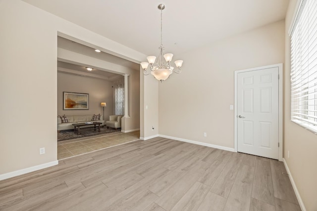 10911 E Swift Ave, Clovis, CA 93619 - empty room featuring light wood-style flooring, a chandelier, and plenty of natural light