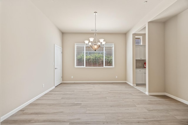 10911 E Swift Ave, Clovis, CA 93619 - unfurnished dining area featuring a chandelier and light wood-style floors
