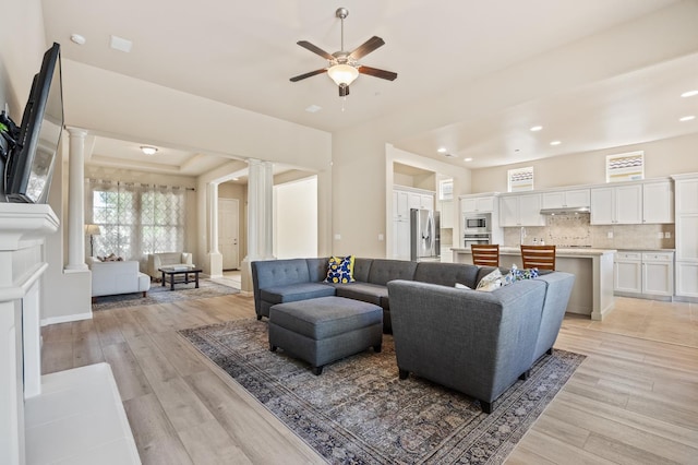 10911 E Swift Ave, Clovis, CA 93619 - living area featuring decorative columns, ceiling fan, light wood-style floors, recessed lighting, and a raised ceiling