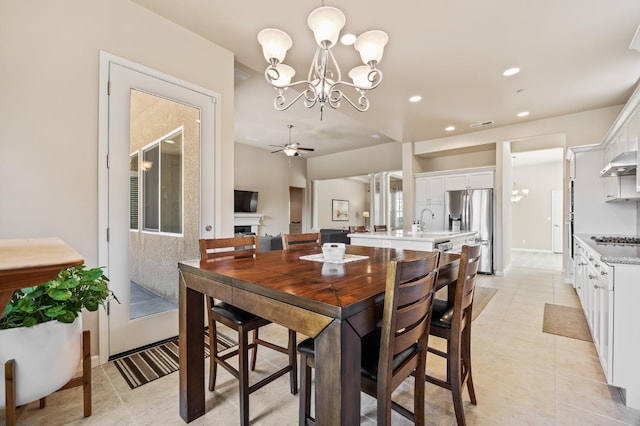 10911 E Swift Ave, Clovis, CA 93619 - dining room with a chandelier, ceiling fan, recessed lighting, light tile patterned flooring, and a fireplace