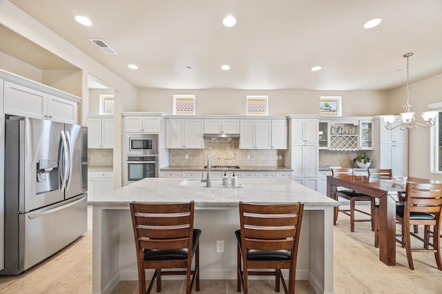 10911 E Swift Ave, Clovis, CA 93619 - kitchen with appliances with stainless steel finishes, white cabinets, tasteful backsplash, recessed lighting, and a kitchen island with sink