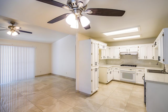 1542 E Alluvial Ave Unit 128, Fresno, CA 93720 - kitchen featuring oven, a ceiling fan, light countertops, and backsplash