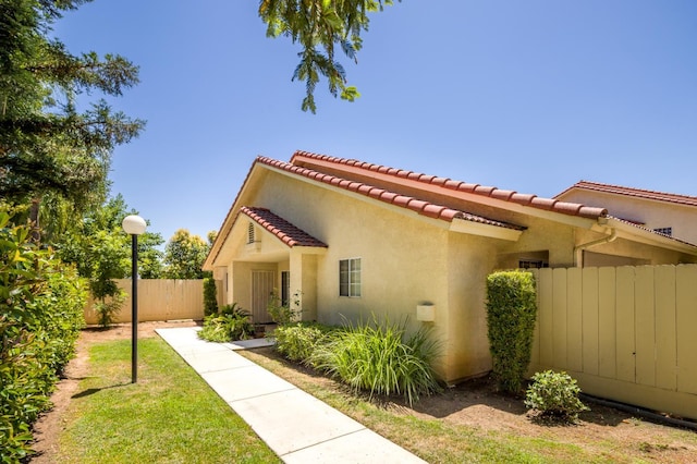 1542 E Alluvial Ave Unit 128, Fresno, CA 93720 - view of front of property with stucco siding and a tile roof