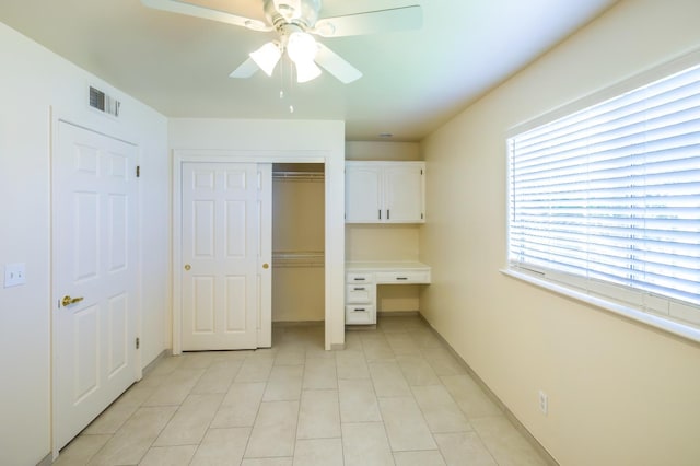 1542 E Alluvial Ave Unit 128, Fresno, CA 93720 - unfurnished bedroom with built in study area, a closet, light tile patterned flooring, and ceiling fan