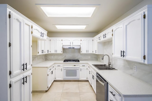 1542 E Alluvial Ave Unit 128, Fresno, CA 93720 - kitchen featuring appliances with stainless steel finishes, under cabinet range hood, decorative backsplash, and white cabinetry