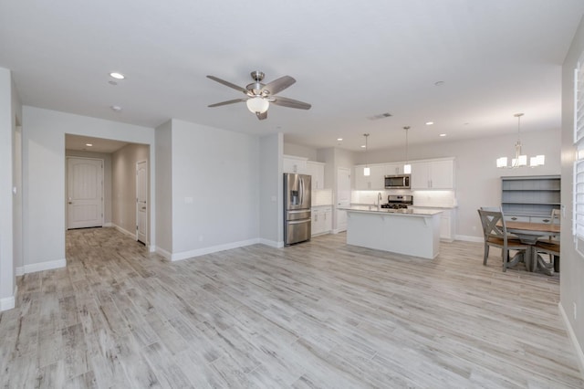 629 Del Monte Ave, Clovis, CA 93619 - living area featuring recessed lighting, light wood finished floors, a ceiling fan, and a chandelier