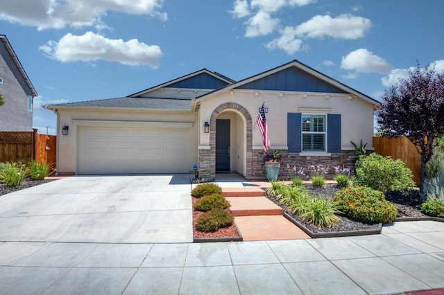 629 Del Monte Ave, Clovis, CA 93619 - view of front of home with driveway, a garage, stucco siding, stone siding, and board and batten siding