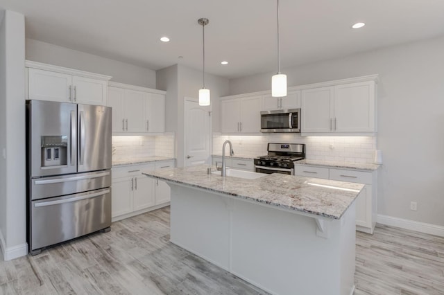 629 Del Monte Ave, Clovis, CA 93619 - kitchen with appliances with stainless steel finishes, white cabinets, recessed lighting, backsplash, and light wood-style floors