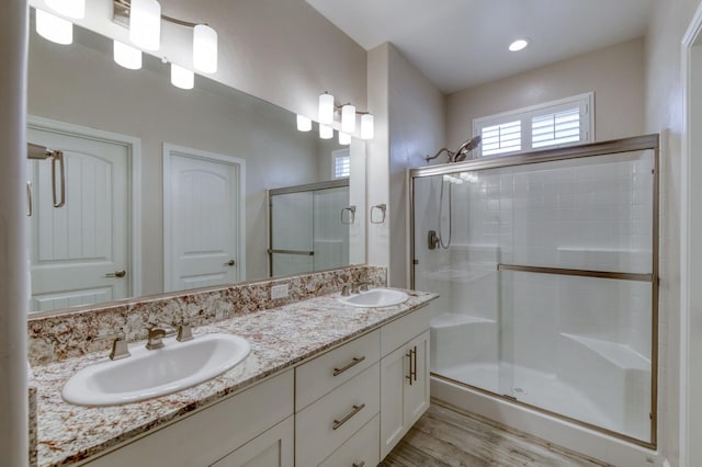 629 Del Monte Ave, Clovis, CA 93619 - full bathroom with a shower stall, double vanity, and wood finished floors