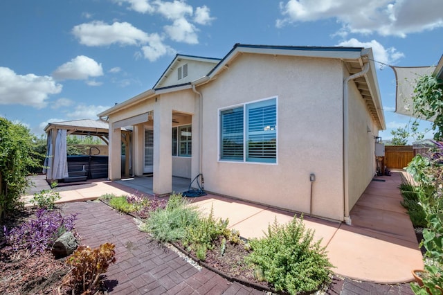 629 Del Monte Ave, Clovis, CA 93619 - back of property featuring a patio, a gazebo, stucco siding, and a hot tub