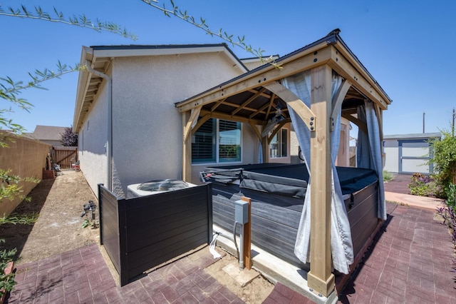 629 Del Monte Ave, Clovis, CA 93619 - rear view of property featuring a hot tub, a fenced backyard, stucco siding, a patio area, and an outdoor structure