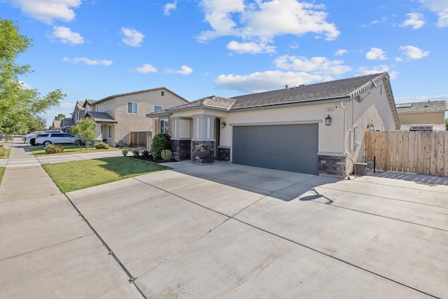 1066 Jade Way, Lemoore, CA 93245 - view of front facade with stucco siding, concrete driveway, stone siding, and a garage